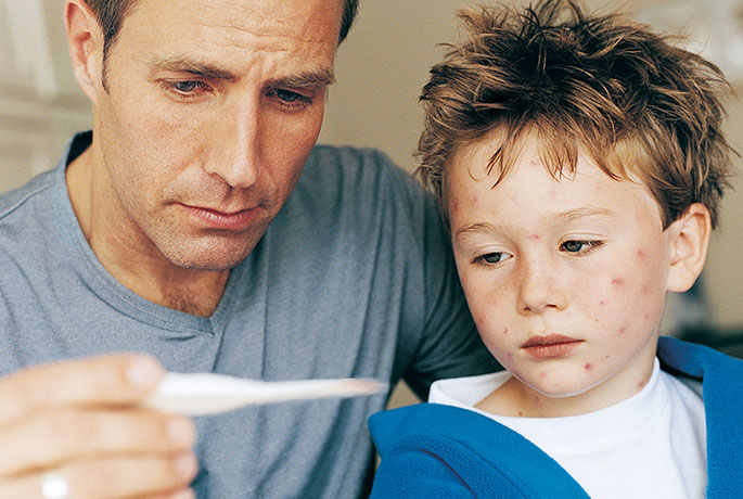 Dad taking child's temperature